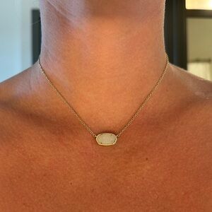 Kendra Scott gold necklace.